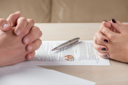 Hands of Couple who Signed Uncontested Divorce Agreement - KM Family Law