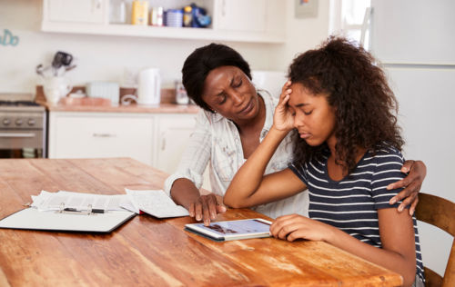 Mother Comforting Teen Daughter Who is Stressed Due to Parents' Divorce - KM Family Law