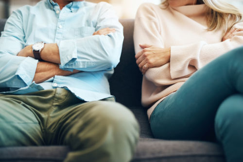 Couple on Couch Discussing Uncontested Divorce - KM Family Law