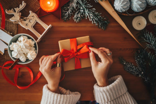 Woman wrapping a Christmas gift